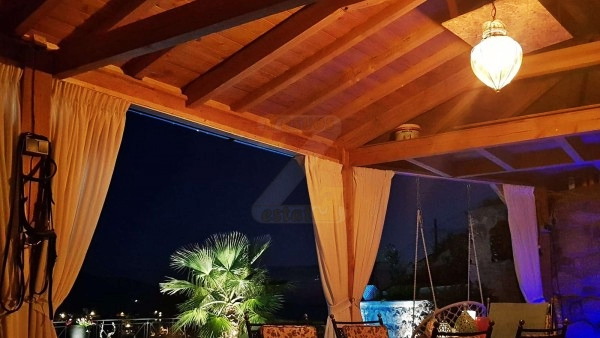 Covered poolside pergola with night views in Anaxos, Lesvos