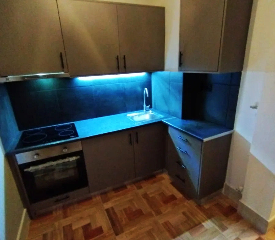 Renovated kitchen with dark cabinets and under-cabinet lighting in an apartment in Ano Patisia, Athens
