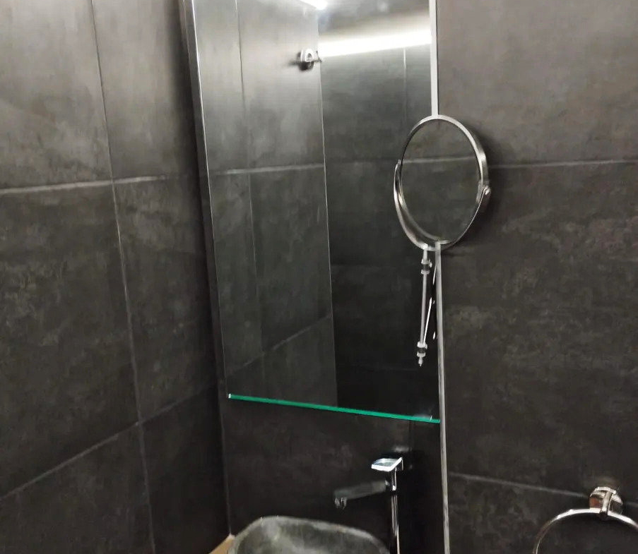 Bathroom vanity with a countertop basin and mirror in an apartment in Ano Patisia, Athens