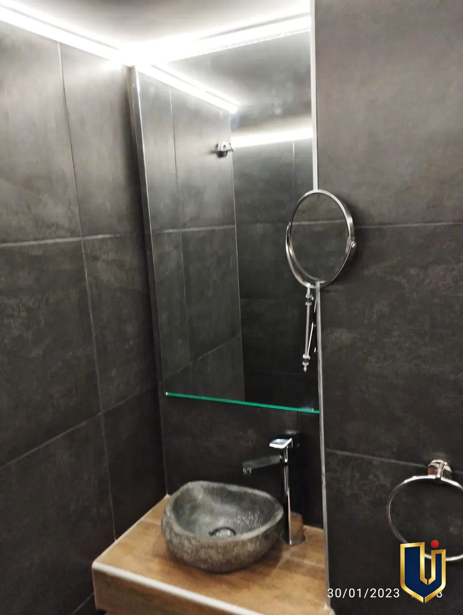 Bathroom vanity with a countertop basin and mirror in an apartment in Ano Patisia, Athens