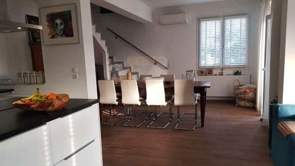 Dining area and staircase leading to the bedrooms in a villa in Anaxos, Lesvos