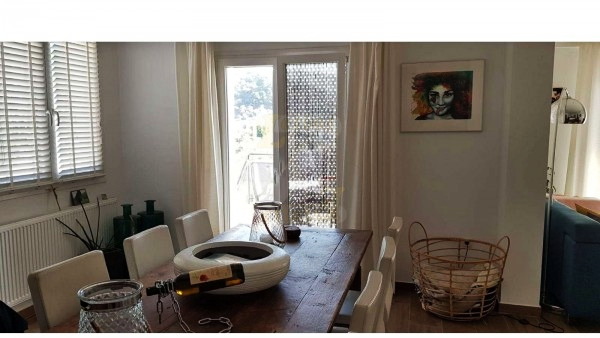 Large dining table and balcony door in a villa in Anaxos, Lesvos