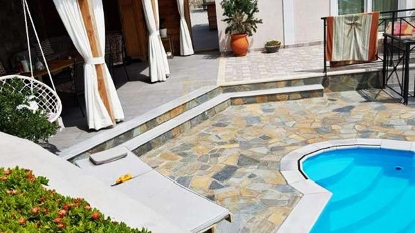 Private swimming pool and stone patio at a villa in Anaxos, Lesvos