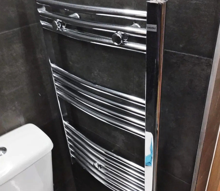 Wall-mounted heated towel rail in an apartment bathroom in Ano Patisia, Athens
