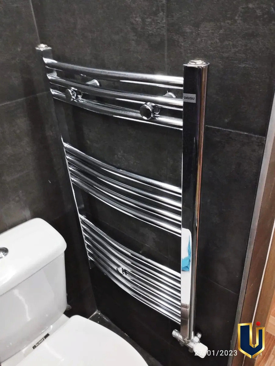 Wall-mounted heated towel rail in an apartment bathroom in Ano Patisia, Athens