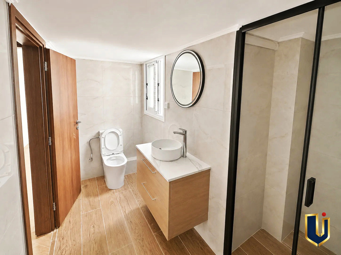 Renovated Bathroom in Kato Patissia Penthouse | Urban Keys Real Estate Renovated bathroom with a shower, toilet, and sink in a penthouse in Kato Patissia, Athens.
