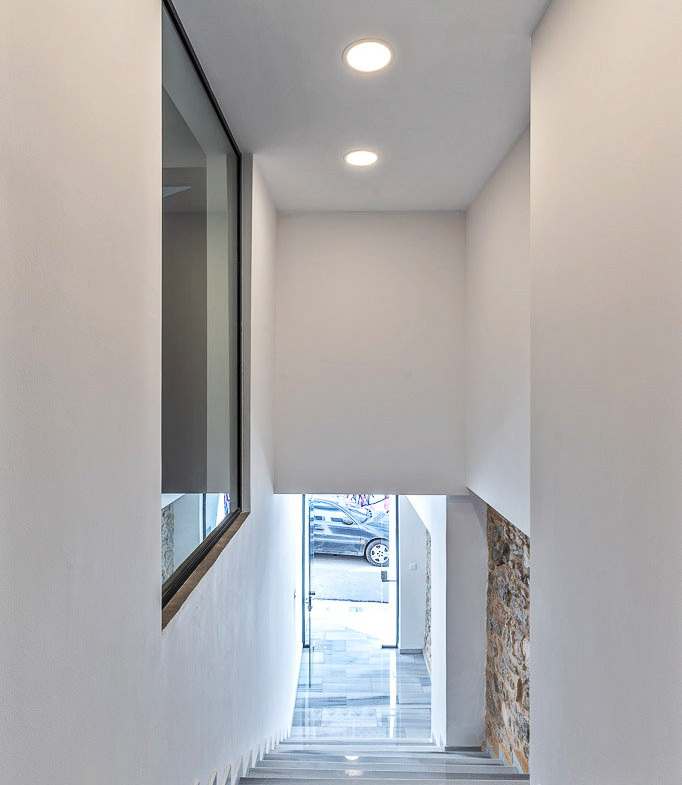 Bright interior corridor leading to the entrance of the Athens investment building, property 150-1075.