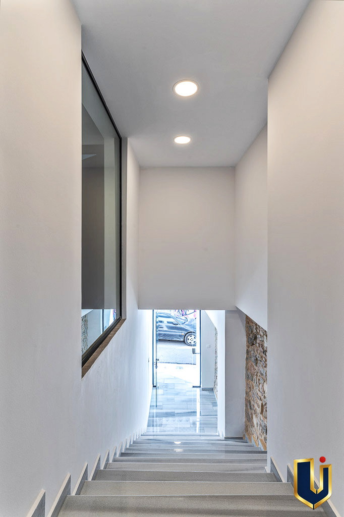 Bright interior corridor leading to the entrance of the Athens investment building, property 150-1075.