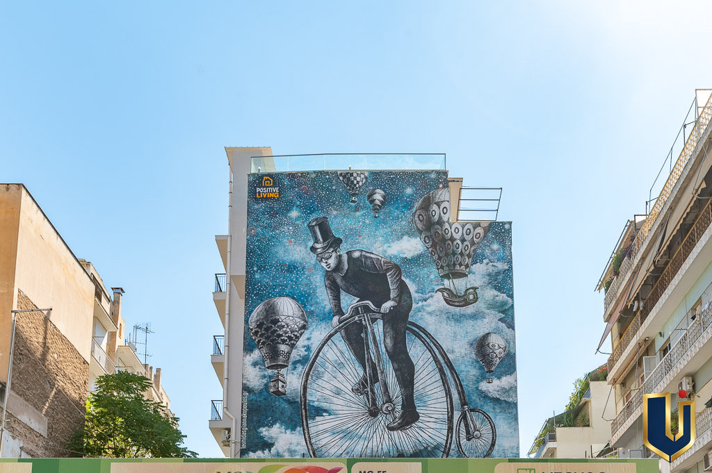 Large urban mural on a building facade near property 150-1075 in Athens.