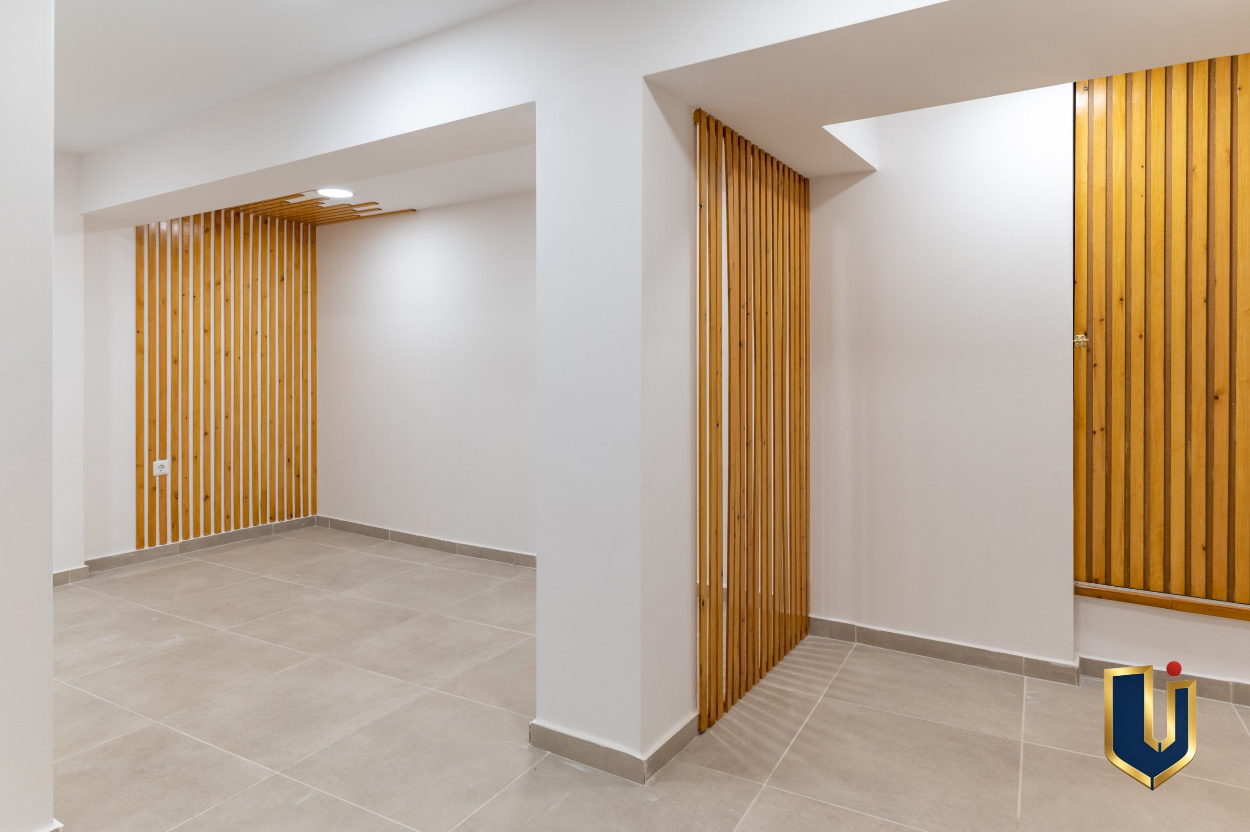 Bright interior space with wooden slat details in the Athens investment building, property 150-1075.