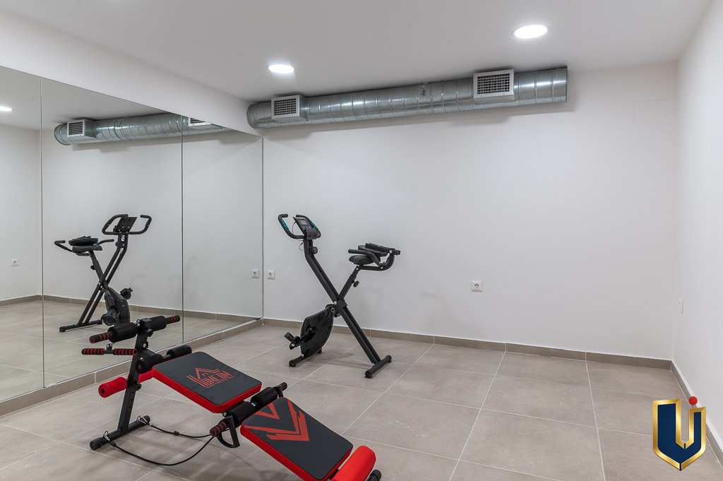 Fitness room with exercise equipment in the Athens investment building, property 150-1075.