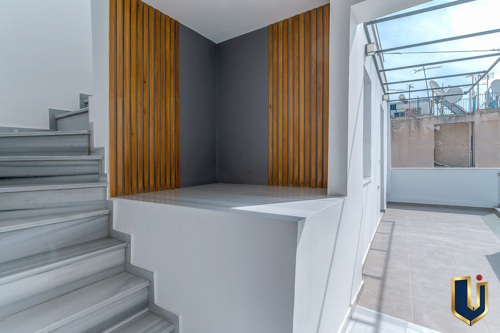 Staircase and glazed landing inside the investment building, property 150-1075 in Athens.