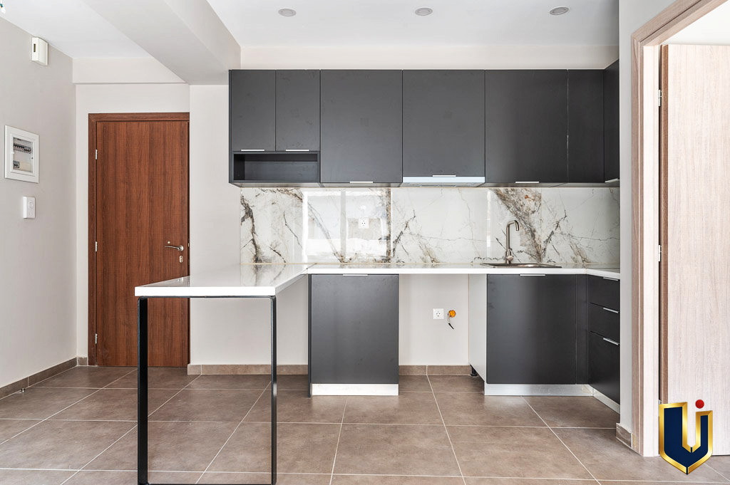 Fitted apartment kitchen with cabinets and a central counter, property 150-1075 in Athens.