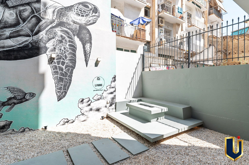 Athens property courtyard with a painted turtle mural and outdoor seating, property 150-1075.