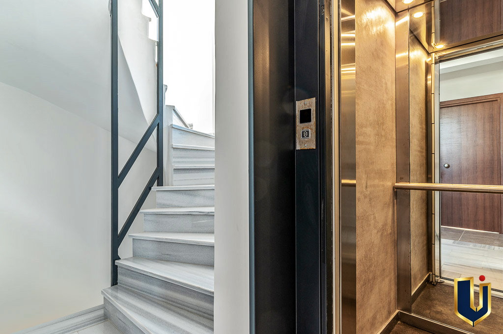 Elevator entrance beside the staircase in Athens investment property 150-1075.