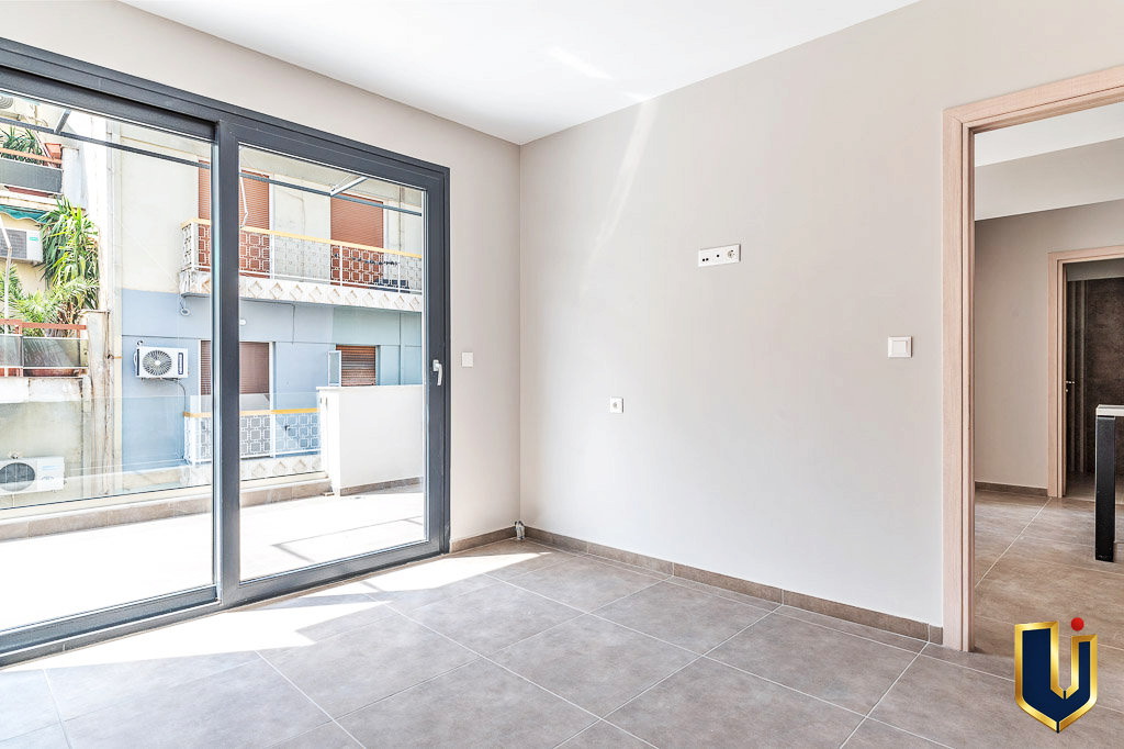 Bright apartment interior with balcony doors and an interior doorway, property 150-1075 in Athens.