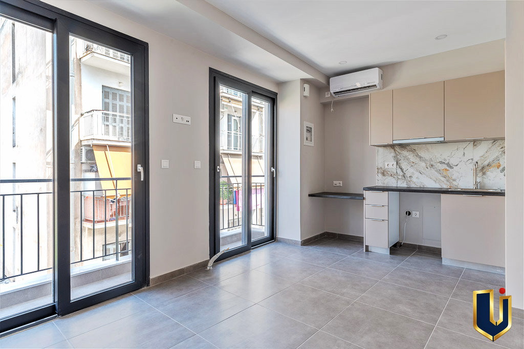 Apartment interior with a fitted kitchen and balcony doors, property 150-1075 in Athens.