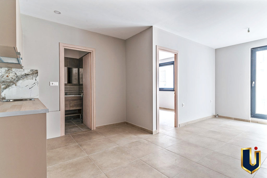 Apartment interior showing part of the kitchen and a room with balcony doors, property 150-1075 in Athens.